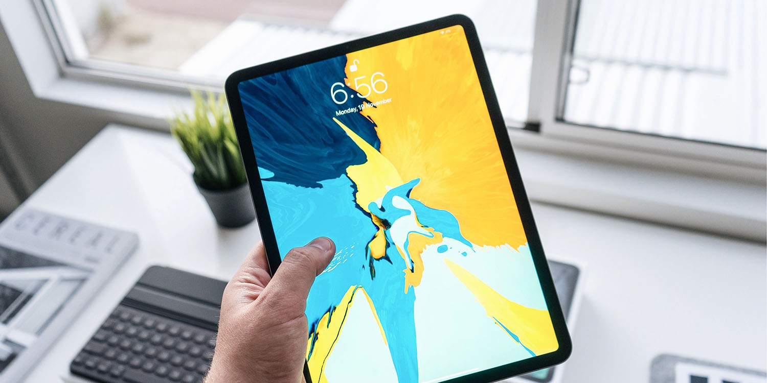 OLED iPads | 12.9-inch iPad Pro held over desk